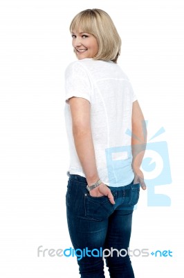 Smartly Dressed Woman With Hands In Back Pocket Of Jeans Stock Photo