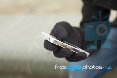 Smartphone In Gloves Stock Photo