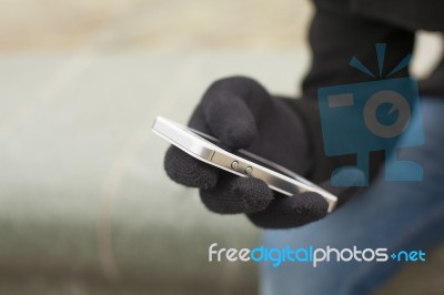 Smartphone In Gloves Stock Photo