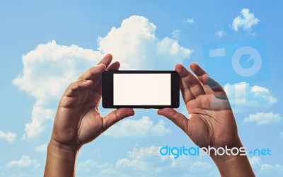 Smartphone In Hand And Blue Sky Stock Photo