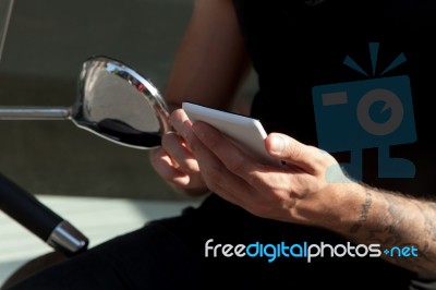 Smartphone In Hands And Moped Stock Photo