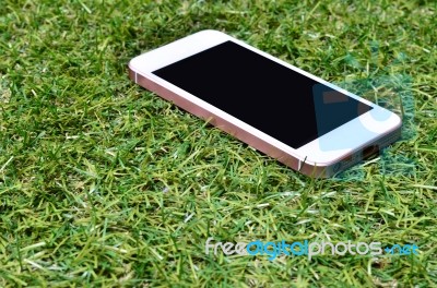 Smartphone On Grass Background Stock Photo