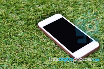 Smartphone On Grass Background Stock Photo