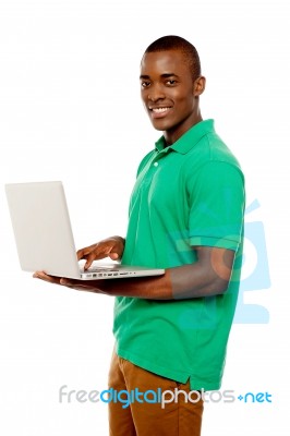 Smiling African Guy Using Laptop Stock Photo