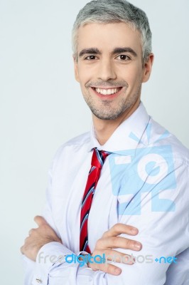 Smiling Arms Crossed Senior Businessman Stock Photo