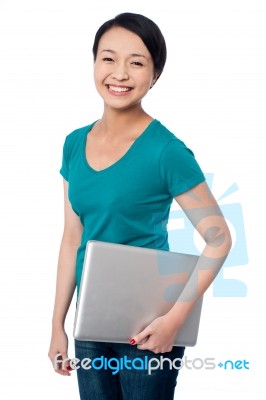 Smiling Asian Female Posing With Laptop Stock Photo