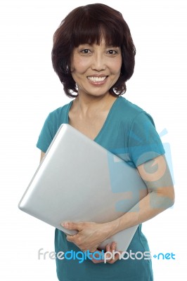 Smiling Asian Woman Carrying Laptop Stock Photo