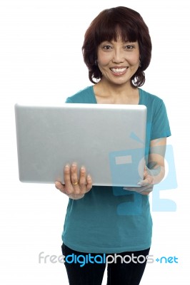 Smiling Asian Woman Holding Laptop Stock Photo