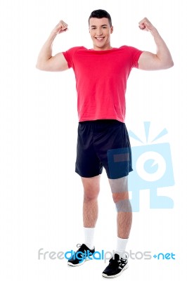 Smiling Athlete Raising His Fists In Excitement Stock Photo