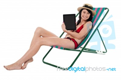 Smiling Bikini Model Promoting Tablet Pc Stock Photo