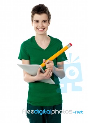 Smiling Boy Drawing On Notebook Stock Photo