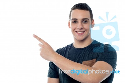 Smiling Boy Pointing Towards Copy Space Area Stock Photo