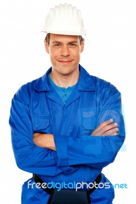 Smiling Builder With Arm Crossed Stock Photo