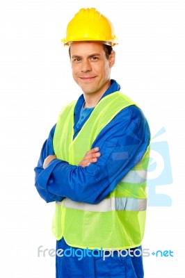 Smiling Builder With Arm Crossed Stock Photo