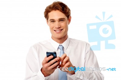 Smiling Business Executive Using Mobile Phone Stock Photo