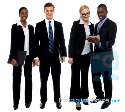 Smiling Business Team Using Tablet Stock Photo