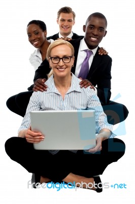 Smiling Business Team With Laptop Stock Photo