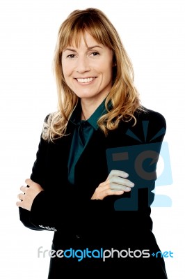 Smiling Business Woman With Folded Arms Stock Photo