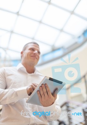 Smiling Businessan With Tablet Computer In Modern Business Build… Stock Photo