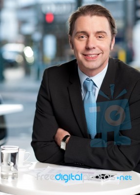 Smiling Businessman At Cafe Stock Photo