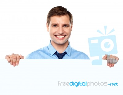 Smiling Businessman Holding Board Stock Photo