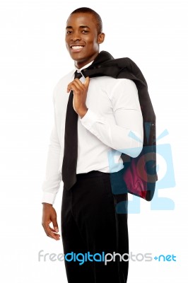 Smiling Businessman Holding Coat Stock Photo