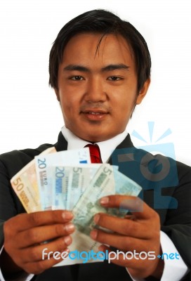 Smiling Businessman Holding Euros Stock Photo