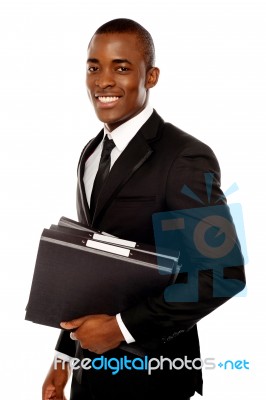 Smiling Businessman Holding Files Stock Photo