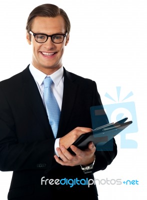 Smiling Businessman Holding Folder Stock Photo