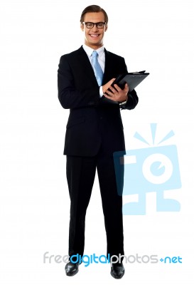 Smiling Businessman Holding Folder Stock Photo