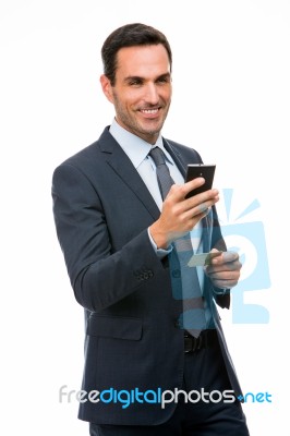 Smiling Businessman Holding Mobile Phone Stock Photo