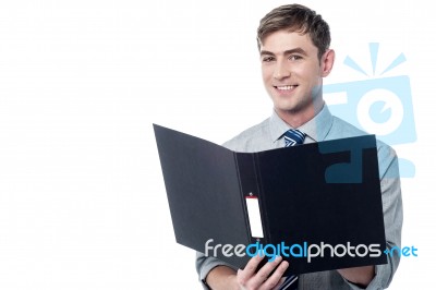 Smiling Businessman Holding The Folder Stock Photo