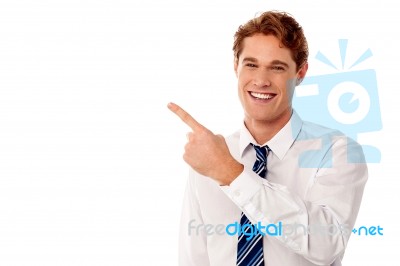 Smiling Businessman Pointing Away Stock Photo