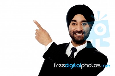 Smiling Businessman Pointing Away Stock Photo