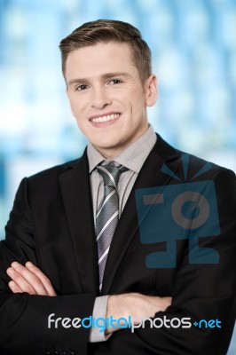 Smiling Businessman Posing Confidently Stock Photo