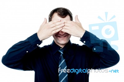 Smiling Businessman Put His Hands Over Eyes Stock Photo