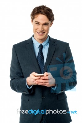 Smiling Businessman Using Mobile Phone Stock Photo