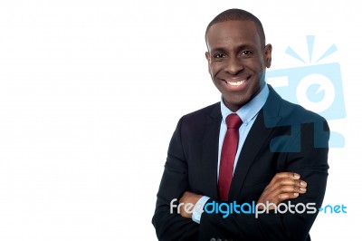 Smiling Businessman With Arms Crossed Stock Photo