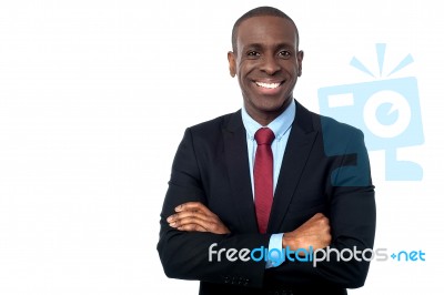 Smiling Businessman With Arms Crossed Stock Photo