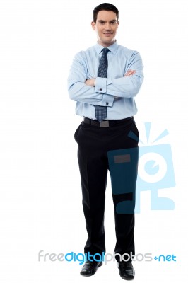 Smiling Businessman With Arms Crossed Stock Photo