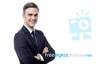 Smiling Businessman With Crossed Arms Stock Photo