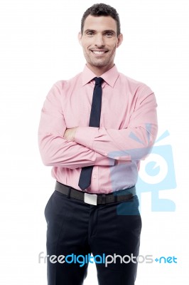 Smiling Businessman With Crossed Arms Stock Photo