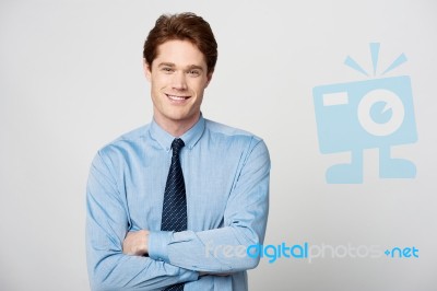 Smiling Businessman With Folded Arms Stock Photo