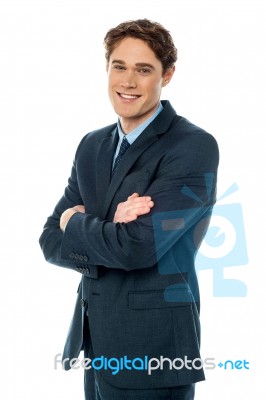 Smiling Businessman With Folded Arms Stock Photo