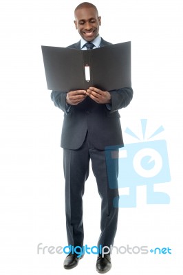 Smiling Businessman With Folder Stock Photo