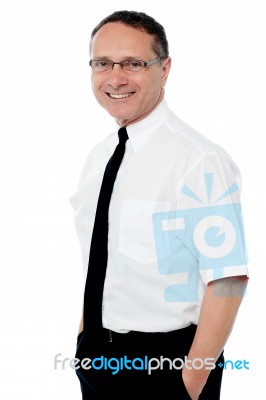 Smiling Businessman With Hands In Pockets Stock Photo