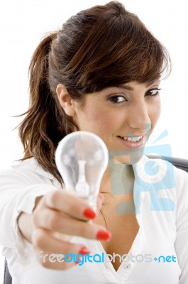 Smiling Businesswoman Holding Bulb Stock Photo