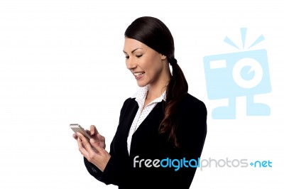 Smiling Businesswoman Using Mobile Phone Stock Photo