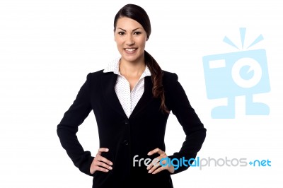 Smiling Businesswoman With Hands On Hips Stock Photo