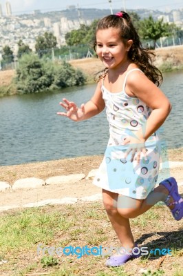 Smiling Caucasian Girl Running Stock Photo